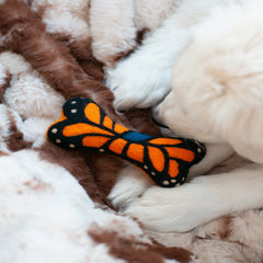 Butterfly-shaped toy on a soft, fluffy surface
