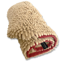 Folded beige blanket with red trim on a white background
